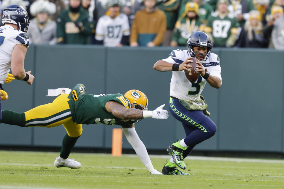 Seattle Seahawks quarterback Russell Wilson (3) runs against the Green Bay Packers during an NFL football game Sunday, Nov 14. 2021, in Green Bay, Wis. (AP Photo/Jeffrey Phelps)