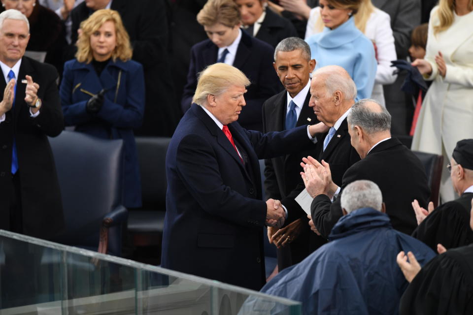 President Trump shakes hands with former Vice President Joe Biden as former President Barack Obama looks on at Trump's inauguration ceremony, Jan. 20, 2017. (Photo by Jonathan Newton /The Washington Post via Getty Images)