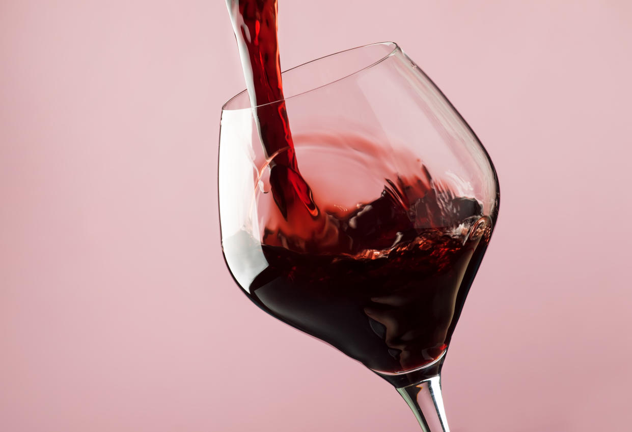 Red wine poured into a glass