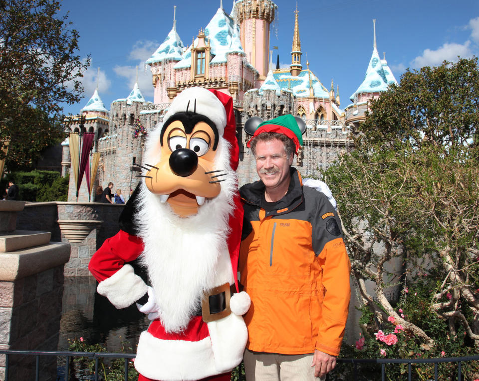 Will Ferrell, star of the popular holiday film 'Elf,' dons a Mickey Mouse-inspired Elf hat and poses with Santa Goofy in front of the holiday-themed Sleeping Beauty Castle November 9, 2012 at Disneyland Park in Anaheim, California.  (Photo by Paul Hiffmeyer/Disney Parks via Getty Images)