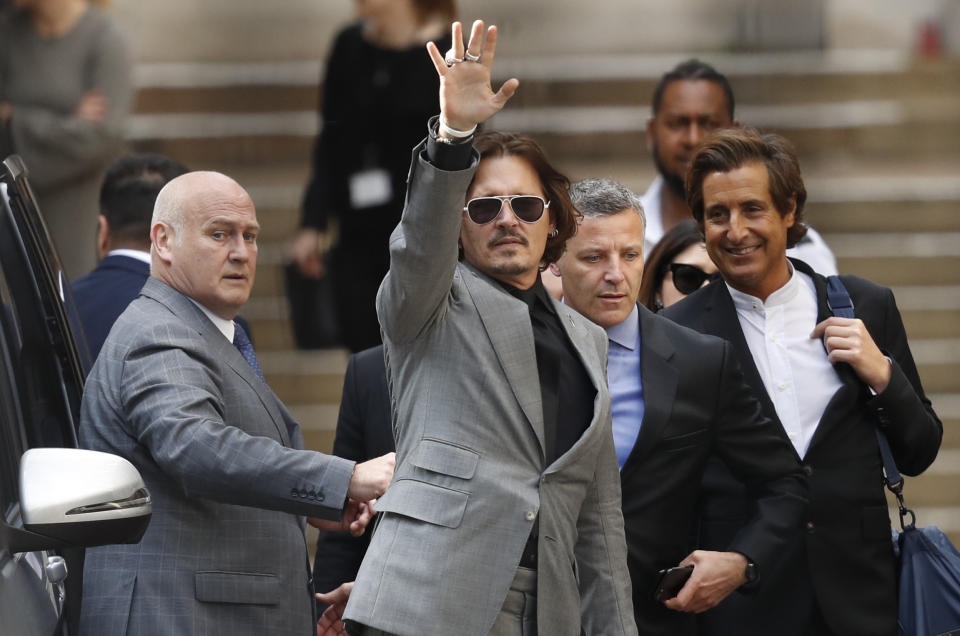 American actor Johnny Depp, waves as he leaves after the end of the trial at the High Court in London, Tuesday, July 28, 2020. Hollywood actor Johnny Depp is suing News Group Newspapers over a story about his former wife Amber Heard, published in The Sun in 2018 which branded him a 'wife beater', a claim he denies. (AP Photo/Alastair Grant)