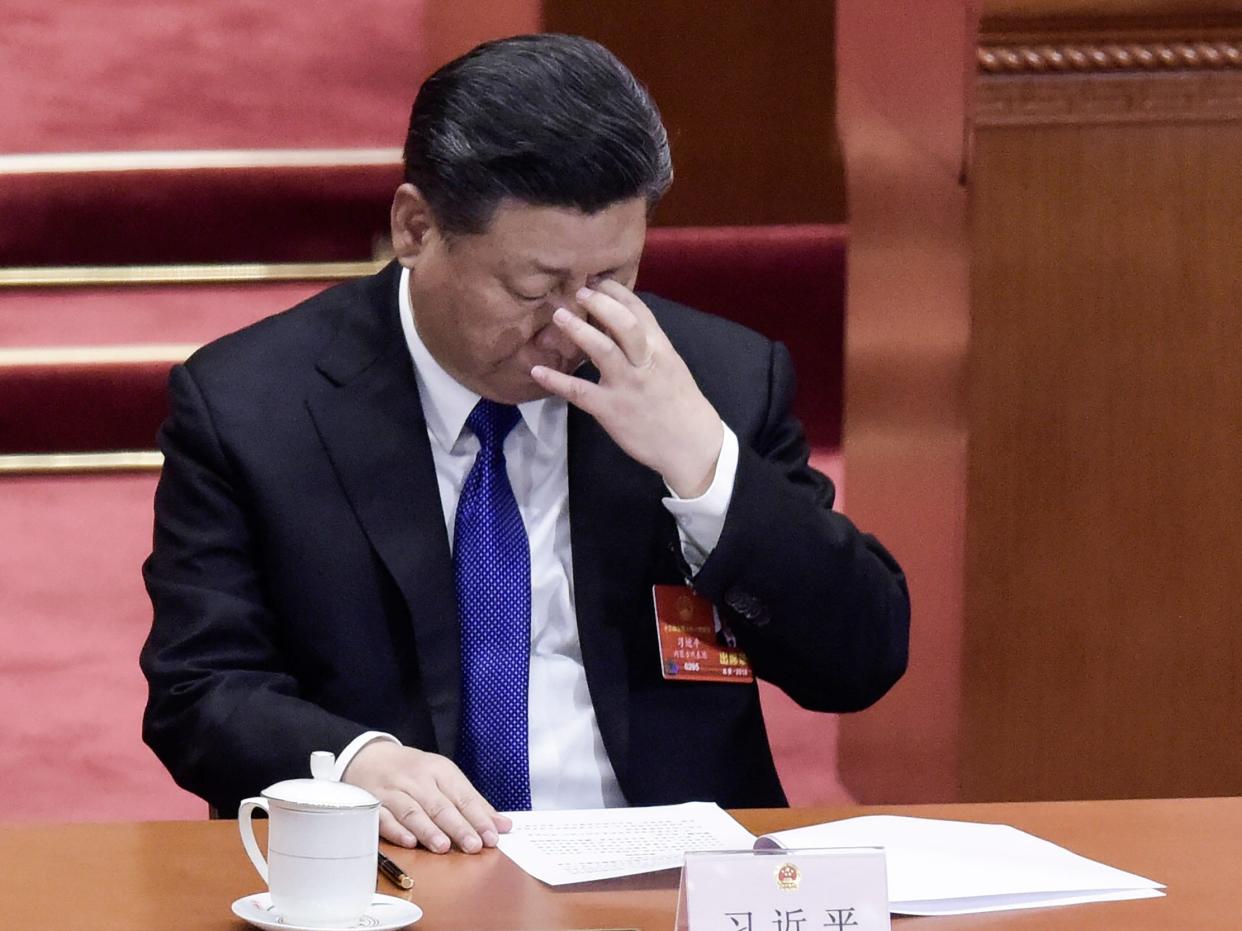 China's President Xi Jinping rubs his eyes