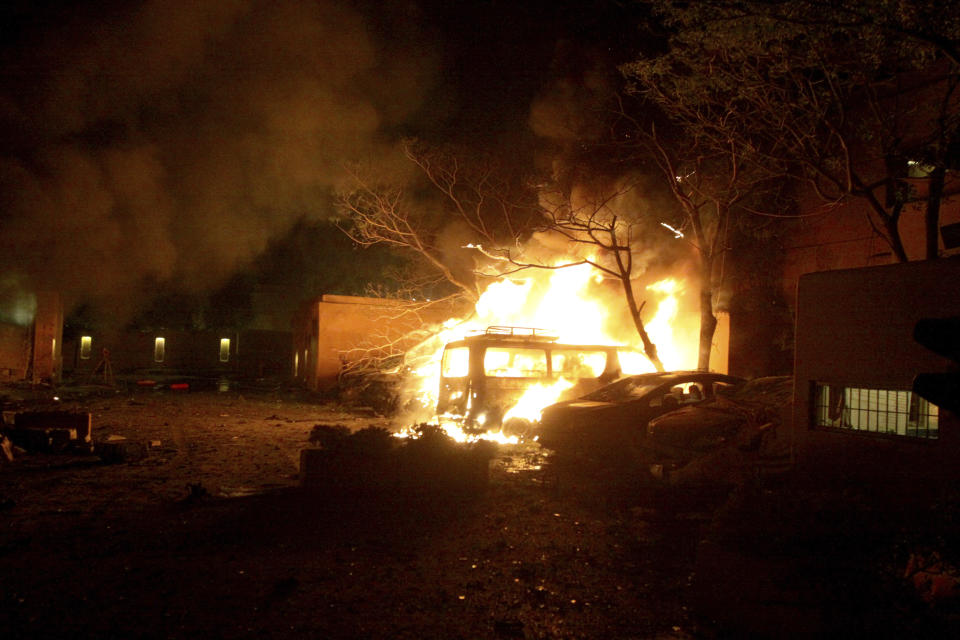 Smoke blows from a burning vehicles at the site of bomb blast in Quetta, Pakistan, Wednesday, April 21, 2021. A powerful bomb went off in the parking area of a five-star Serena hotel in the southwestern city of Quetta on Wednesday, wounding some people, police said. (AP Photo/Arshad Butt)