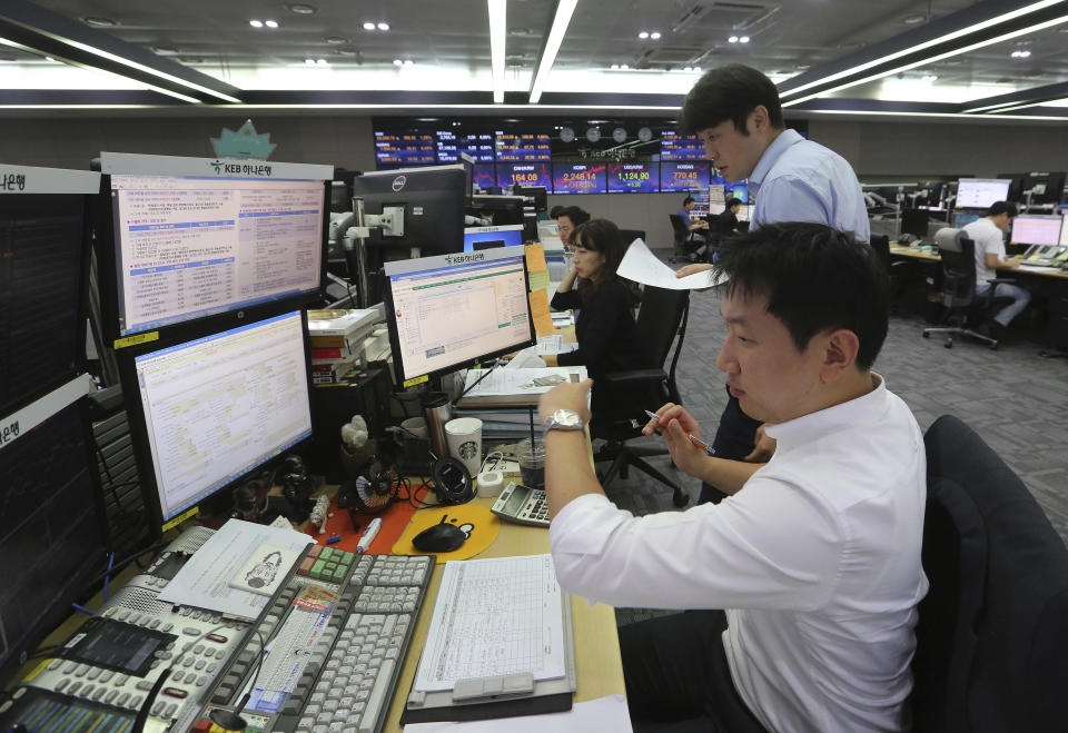 Currency traders work at the foreign exchange dealing room of the KEB Hana Bank headquarters in Seoul, South Korea, Friday, Aug. 17, 2018. Asian shares made moderate gains early Friday after U.S. stocks jumped on news China is preparing to resume trade discussions with the U.S., the first negotiations in more than a month.(AP Photo/Ahn Young-joon)