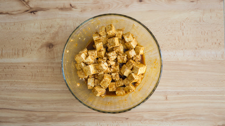 tofu cubes marinating in bowl 