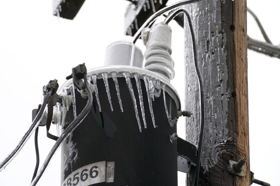 An electrical transformer is coated in ice and icicles from a few days of rain and sleet, Thursday, Feb. 2, 2023, in Dallas. (AP Photo/Tony Gutierrez)