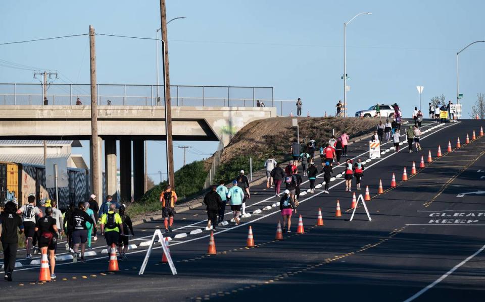 Runners head out and return on 9th Street during the Modesto Marathon in Modesto, Calif., Sunday, March 26, 2023. In addition to the marathon, runners participated in half-marathon, 10k and 5k races.