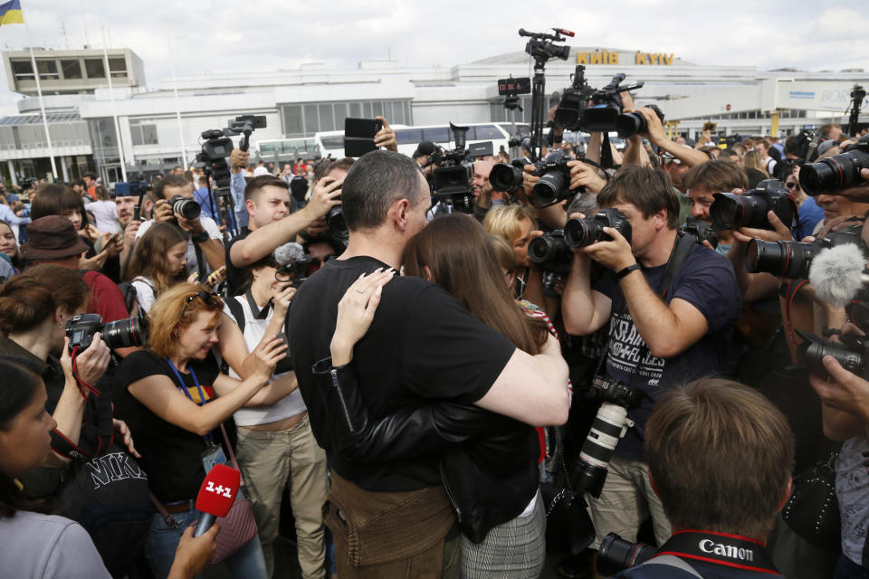 Ukrainian filmmaker Oleg Sentsov hugs his daughter upon his arrival at Boryspil airport, outside Kyiv, Ukraine, Saturday, Sept. 7, 2019. Planes carrying prisoners freed by Russia and Ukraine have landed in the countries' capitals, in an exchange that could be a significant step toward improving relations between Moscow and Kyiv. The planes, each reportedly carrying 35 prisoners, landed almost simultaneously at Vnukovo airport in Moscow and at Kyiv's Boryspil airport. (AP Photo/Efrem Lukatsky)