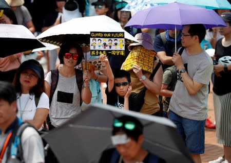 Family members participate in a protest rally titled "Guard Our Children's Future" at Edinburgh Place in Hong Kong, China