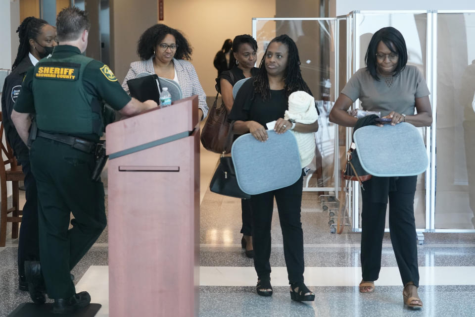Relatives and family members of those injured or killed arrive for the penalty phase trial for convicted Marjory Stoneman Douglas High School shooter Nikolas Cruz, Friday, July 22, 2022, at the Broward County Courthouse in Fort Lauderdale, Fla. (AP Photo/Wilfredo Lee, Pool)