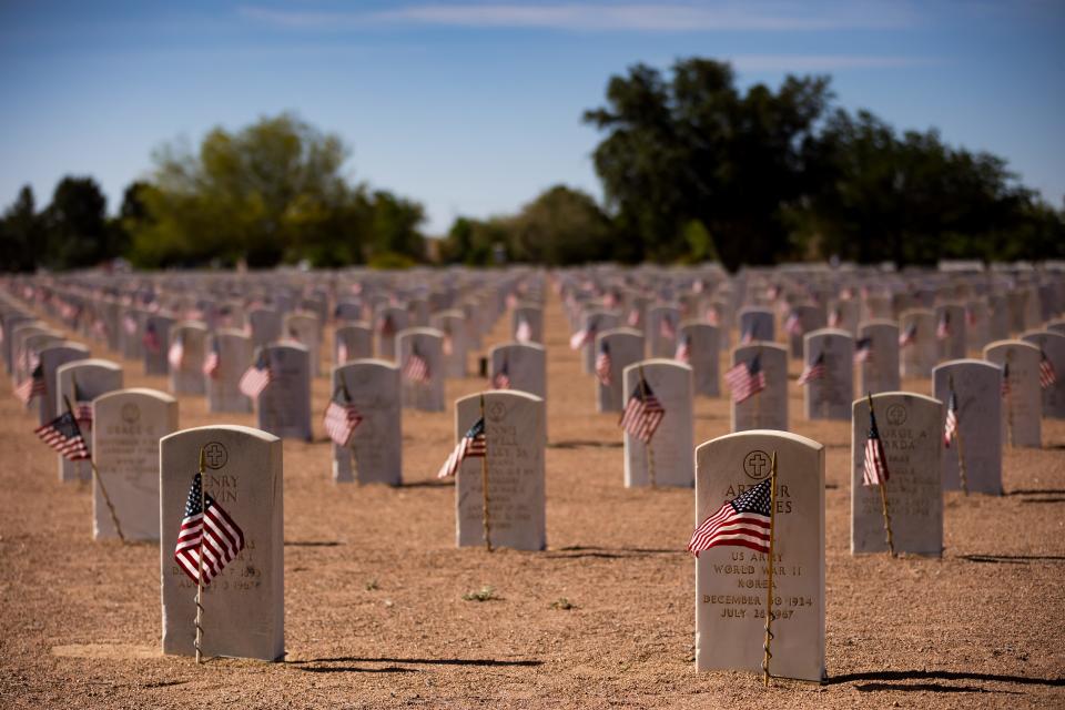 Scouting America, formerly Boy Scouts of America, and Girl Scouts troops place flags on the graves at Fort Bliss Cemetery before Memorial Day on Saturday, May 25, 2024.