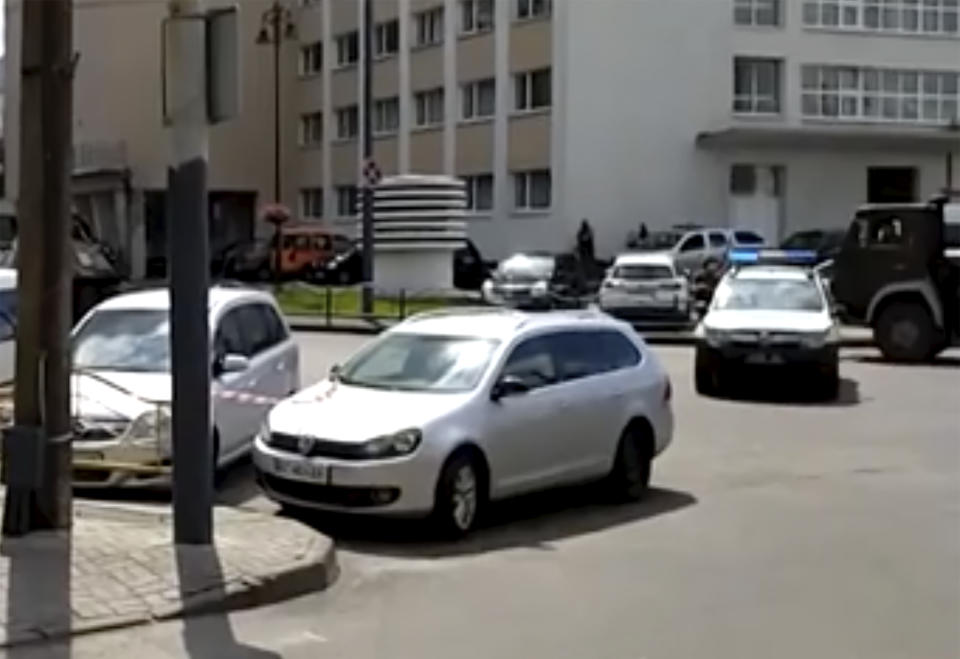 In this image take from video, the scene as police close off the streets, after an armed man seized a bus and took some 20 people hostage in the city centre of Lutsk, some 400 kilometers (250 miles) west of Kyiv, Ukraine on Tuesday July 21, 2020. The assailant is armed and carrying explosives, according to a Facebook statement by Ukrainian police. Police officers are trying to get in touch with the man and they have sealed off the area. (AP Photo)