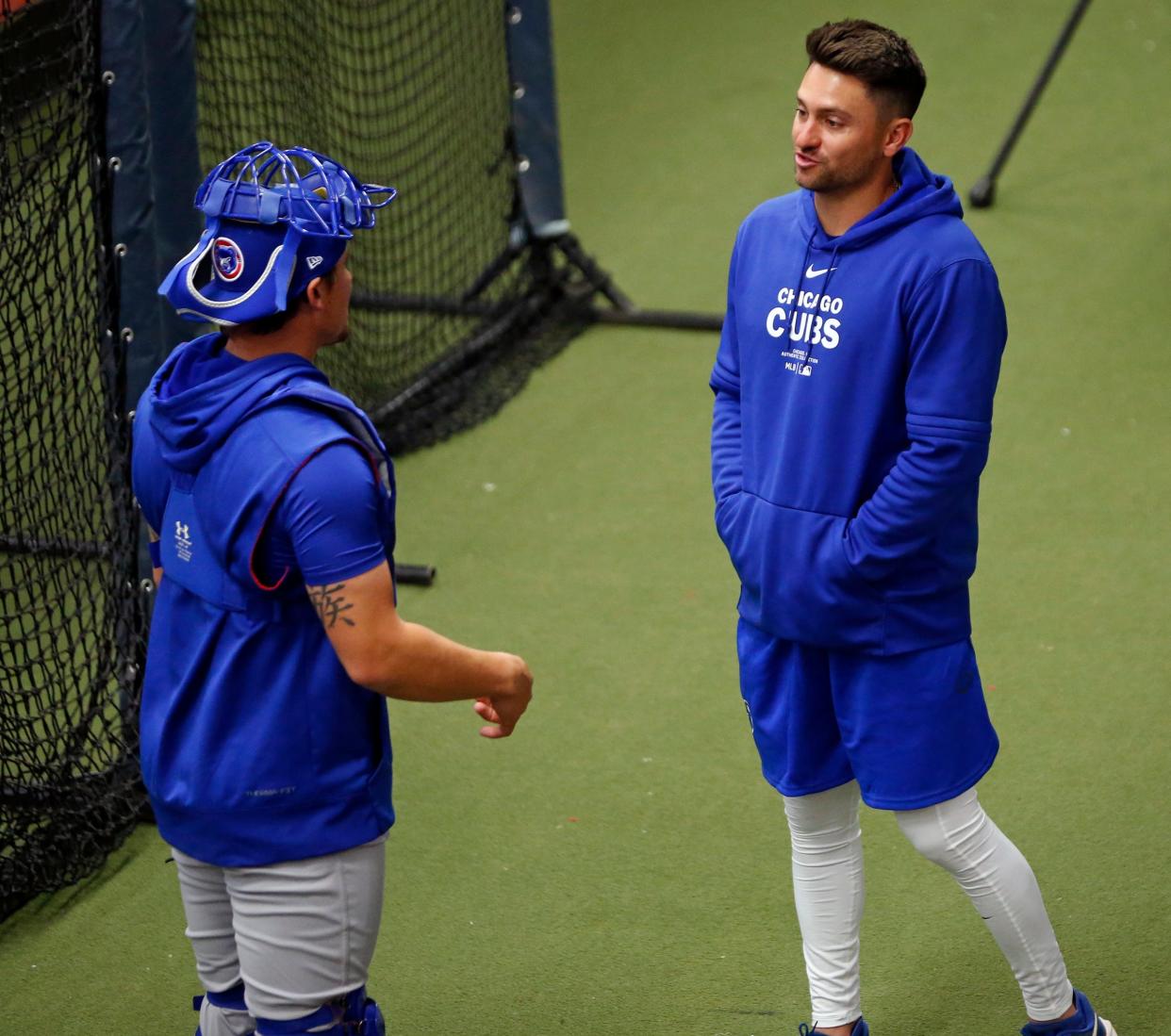 New South Bend Cubs manager Nick Lovullo, right, speaks to catcher Dilan Granadillo after a drill in practice Wednesday, April 3, 2024, at the 1st Source Bank Performance Center in South Bend.