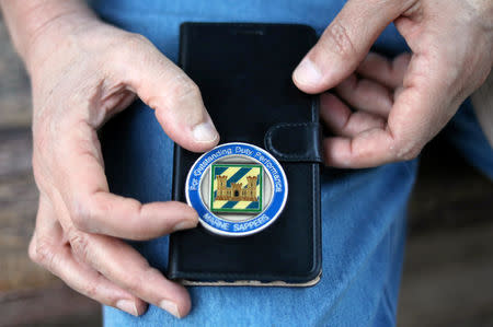 An Iraqi refugee and former interpreter for the U.S. Army in Iraq shows his U.S. military medal on the outskirts of Cairo, Egypt August 8, 2018. REUTERS/Staff