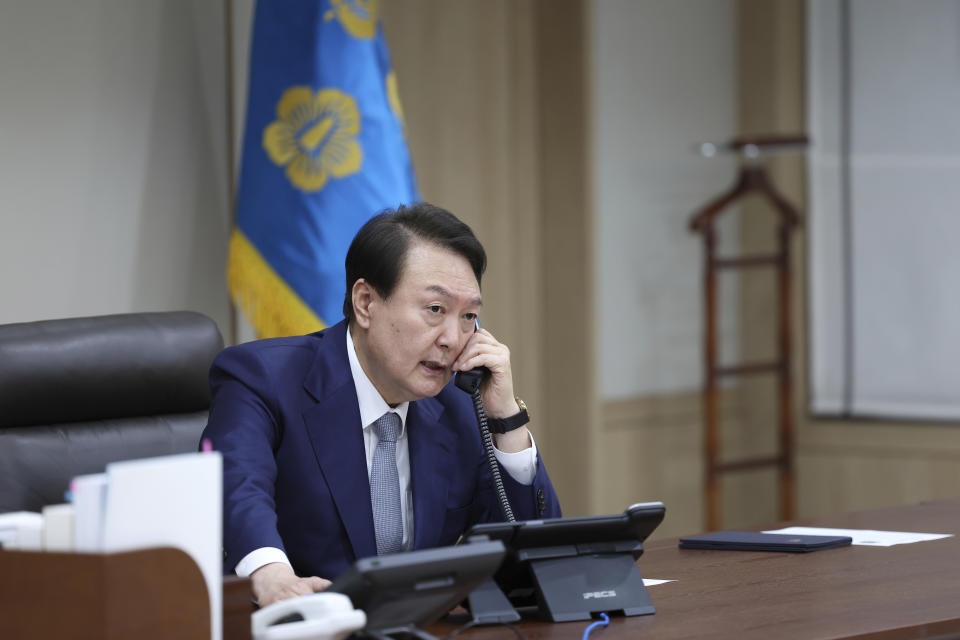 In this photo provided by South Korean Presidential Office, South Korean President Yoon Suk Yeol talks on the phone with Japanese Prime Minister Fumio Kishida in Seoul, South Korea, Thursday, Oct. 6, 2022. South Korean President Yoon Suk Yeol and Japanese Prime Minister Fumio Kishida spoke by phone Thursday and agreed that North Korea's recent missile tests are "a serious, grave provocation" that threatens international peace. (South Korea Presidential Office via AP)