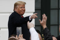 President Donald Trump points after signing a new North American trade agreement with Canada and Mexico, during an event at the White House, Wednesday, Jan. 29, 2020, in Washington. (AP Photo/Alex Brandon)