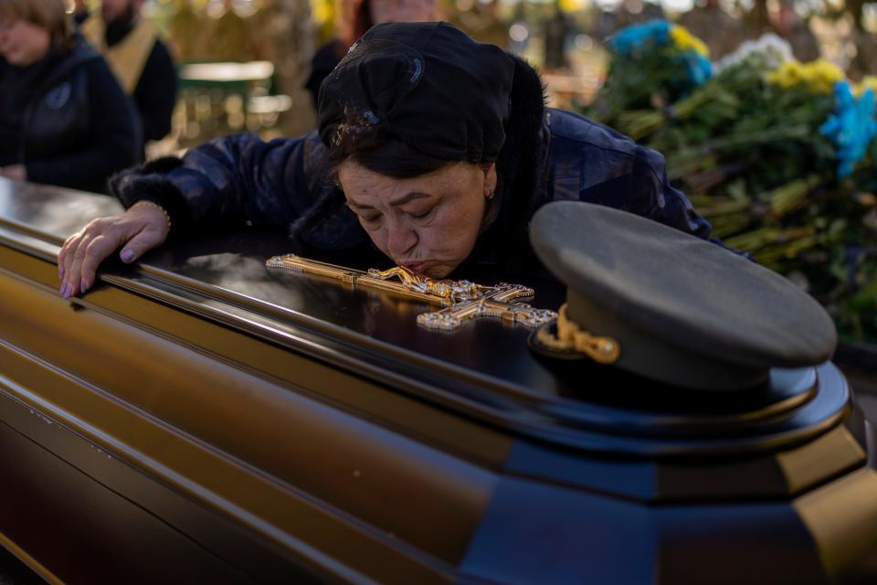 Tatiana Alexeyevna mourns over the coffin of her son Colonel Oleksiy Telizhenko during his funeral in Bucha, near Kyiv, Ukraine, Tuesday, Oct. 18, 2022. In March, Colonel Oleksiy was abducted by Russian soldiers from his home in Bucha; six months later, his body was found with signals of torture buried in a forest not far away from his village.