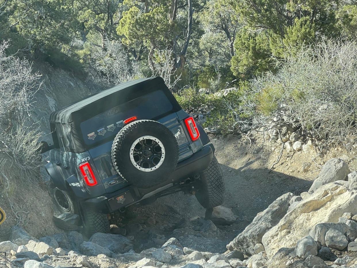 A guide at the Ford Bronco Off-Roadeo in Nevada on April 15, 2024 drives ahead of Detroit Free Press reporter Phoebe Wall Howard to show her how precision driving over rocks protects the vehicle and provides maximum control for off-roading.