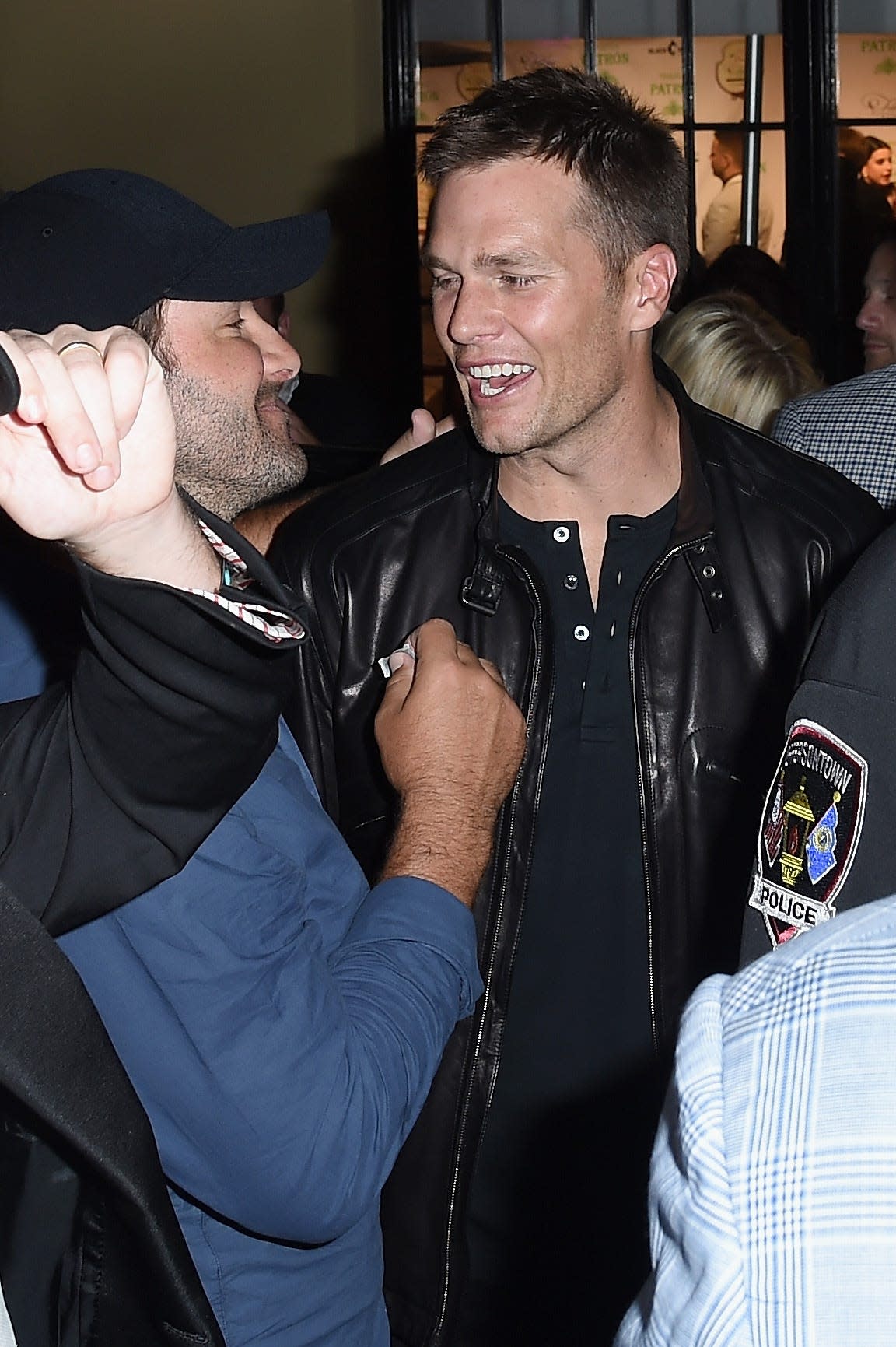 Fillies & Stallions Derby Party: Retired Dallas Cowboys quarterback Tony Romo, left, catches up former New England Patriots quarterback Tom Brady.