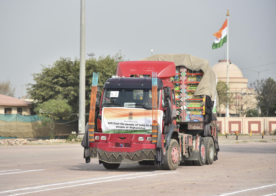 A truck carrying wheat from India waits to pass through the Attari-Wagah border between India and Pakistan, near Amritsar, India, Tuesday, Feb.22, 2022. Last week, Pakistan officials said the country would allow nuclear rival India to deliver wheat to Afghanistan, where millions are struggling through acute food shortages. The arrangement comes more than three months after India announced it would deliver 50,000 metric tons of wheat and life-saving medicine to Afghanistan. (AP Photo/Prabhjot Gill)