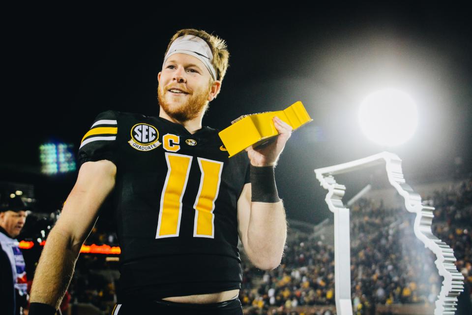 Missouri wide receiver Barrett Banister celebrates with the Battle Line Trophy on Nov. 25, 2022, at Faurot Field in Columbia, Mo. Missouri defeated Arkansas to earn bowl eligibility.