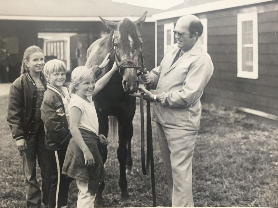 Trainer Buddy Delp (right) shows off Spectacular Bid to a group of children on the backstretch at Monmouth Park in 1980.