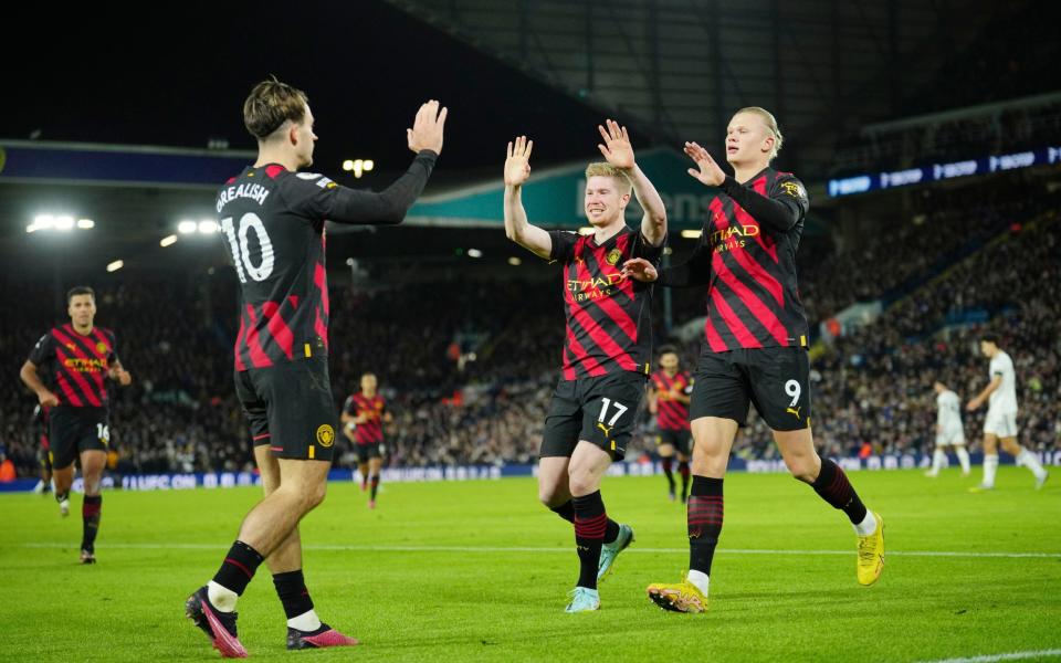 Manchester City's Erling Haaland, right, celebrates with teammates Kevin De Bruyne and Jack Grealish - AP/Jon Super