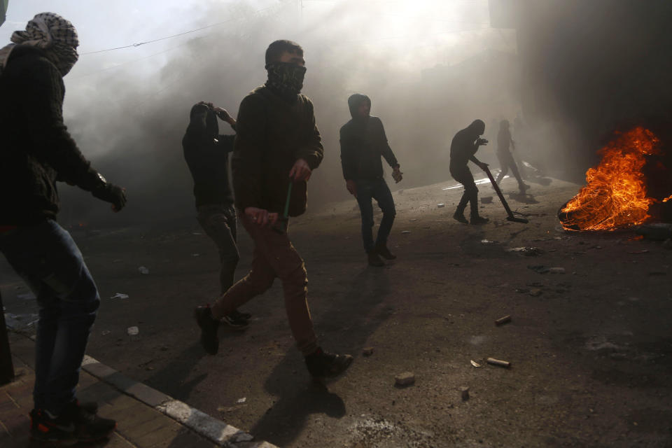 Palestinians hurl stones towards Israeli soldiers during clashes after the funeral of policeman Tariq Badwan in the West Bank village of Azoun near Qalqilya, Friday, Feb. 7, 2020. Badwan was shot while standing at the entrance of a police station in Jenin, where Israeli forces clashed with Palestinians while demolishing the home of an alleged militant. He did not appear to have been involved in the clashes. (AP Photo/Majdi Mohammed)