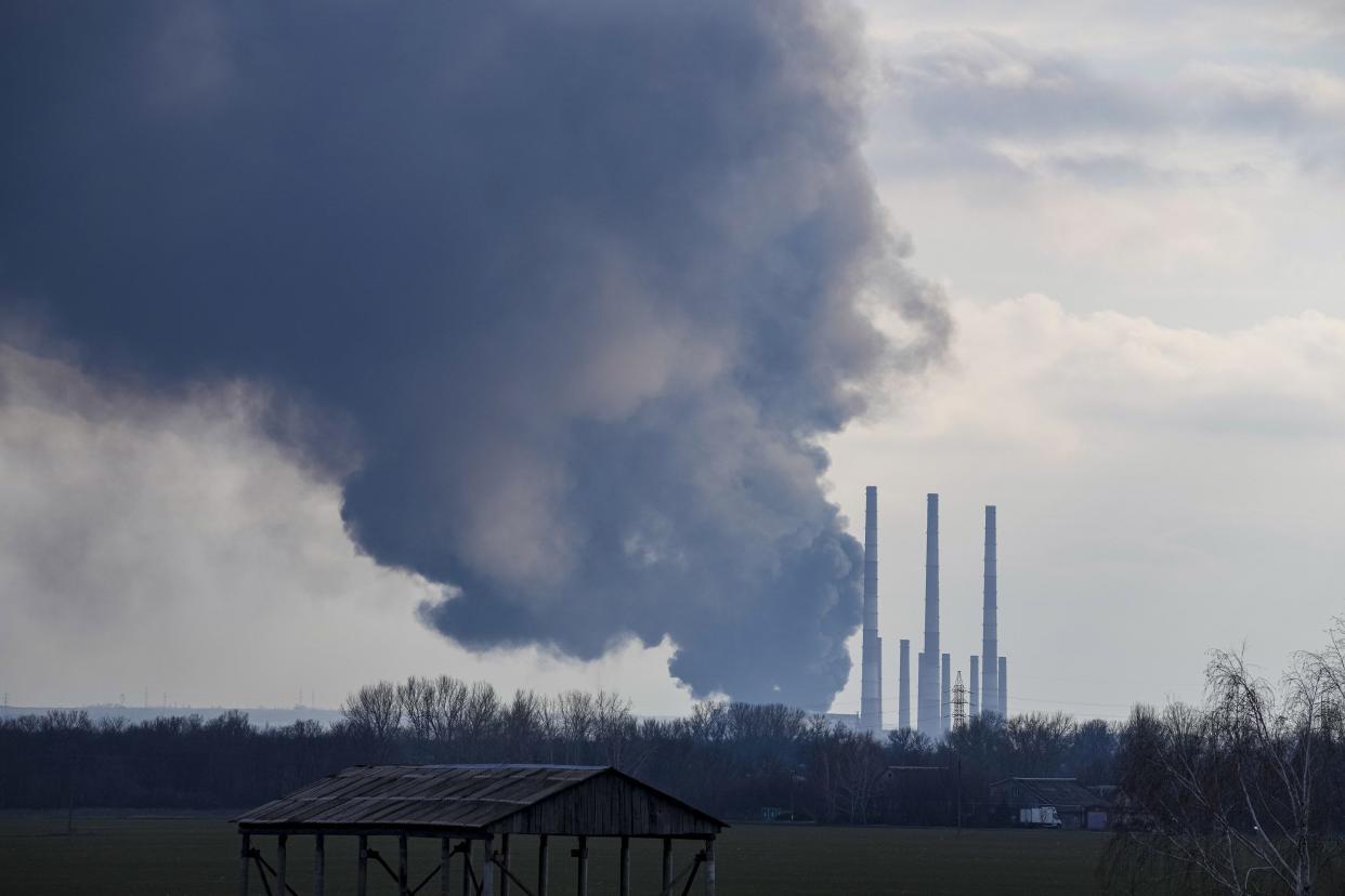 Smoke billows from a power and heating plant after it is was shelled in Shchastya, in the Luhansk region, eastern Ukraine, Tuesday, Feb. 22, 2022. Russia says it's recognition of independence for areas in eastern Ukraine extends to territory currently held by Ukrainian forces. The statement Tuesday further raises the stakes amid Western fears that Moscow could follow up on Monday’s recognition of rebel regions with a full-fledged invasion of Ukraine.