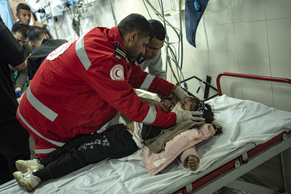 A Palestinian girl wounded in Israeli bombardment of the Gaza Strip is brought to a hospital in Khan Younis, Friday, Dec. 1, 2023. (AP Photo/Fatima Shbair)