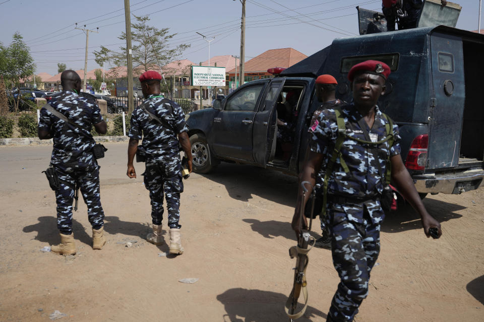 Police officers patrol the area at the entrance of the Independent National Electoral Commission office in Yola, Nigeria Sunday, Feb. 26, 2023. Nigerians voted Saturday to choose a new president, following the second and final term of incumbent Muhammadu Buhari. (AP Photo/Sunday Alamba)