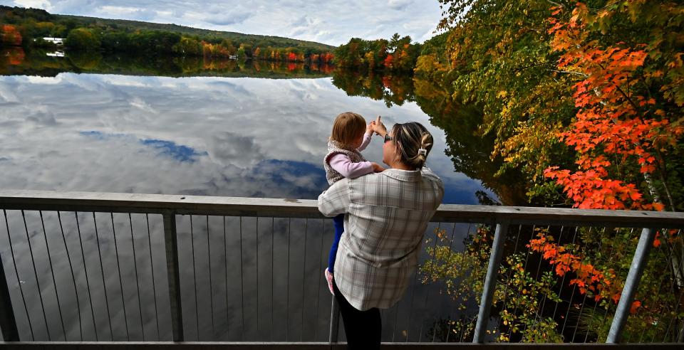 Anna Pawelchzyk of Leicester shows her daughter, Julia McCluskey, 2, the fall foliage from the boardwalk at Coes Pond.