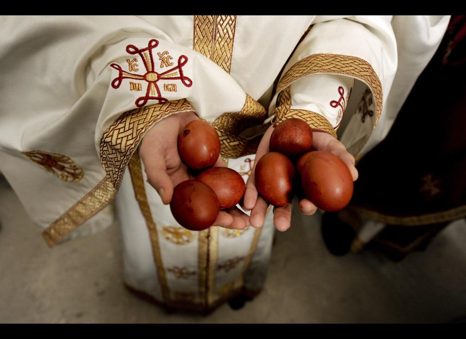 A Kosovo Serb priest hold hand-painted easter eggs as he takes part in a religious service at the St.Sava church in the town of Mitrovica during a Orthodox Easter on April 5, 2010. Traditionally Orthodox Serbs observe Easter according to the old Julian calendar. AFP PHOTO / ARMEND NIMANI