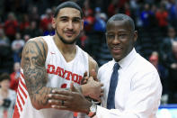 FILE - In this Feb. 22, 2020, file photo, Dayton's Obi Toppin, left, celebrates scoring his 1,000th career point with head coach Anthony Grant after an NCAA college basketball game against Duquesne, in Dayton, Ohio. Toppin and Grant have claimed top honors from The Associated Press after leading the Flyers to a No. 3 final ranking. Toppin was voted the AP men's college basketball player of the year, Tuesday, March 24, 2020. Grant is the AP coach of the year. (AP Photo/Aaron Doster, File)