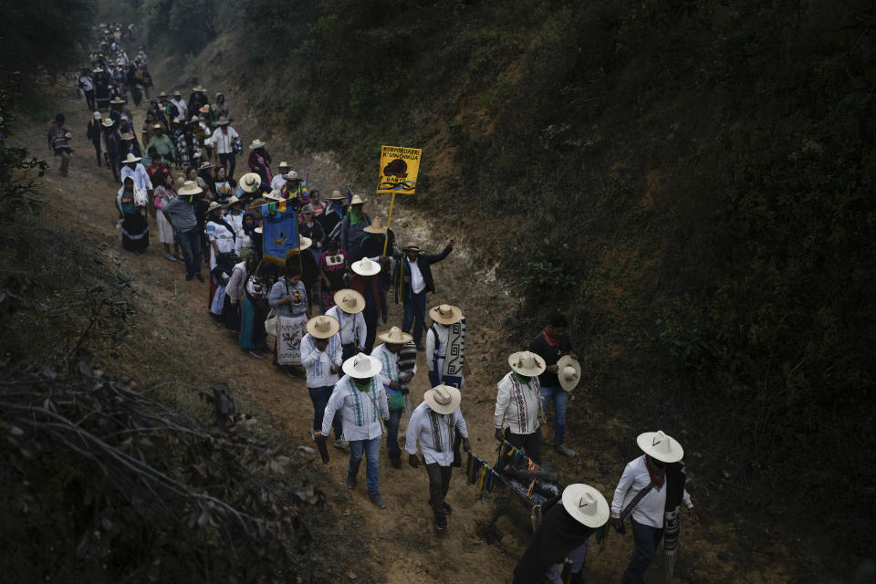 Purepechas Indigenous people carry a flame through the mountains, from Erongaricuaro where residents kept the flame alive for one year, to the residents of Ocumicho in Michoacan state, Mexico, Wednesday, Jan. 31, 2024. A new flame will be lit in Ocumicho at the “New Fire” ceremony on Feb. 2 to mark the new year, after extinguishing the old fire on Feb. 1 which is considered an orphan day that belongs to no month and is used for mourning and renewal. (AP Photo/Eduardo Verdugo)