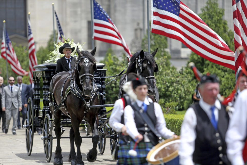 A horse-drawn carriage carries former Louisiana Governor Edwin Edwards away from the Louisiana State Capitol in Baton Rouge, La., Sunday, July 18, 2021. A processional featuring a law enforcement motorcade and the Southern University Marching Band was held though the streets of downtown Baton Rouge, ending at the Old State Capital building where a private funeral service was held. The colorful and controversial four-term governor died of a respiratory illness on Monday, July 12th at the age of 93. (AP Photo/Michael DeMocker)