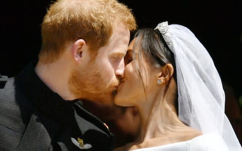 Prince Harry and Meghan Markle kiss - Credit: PA