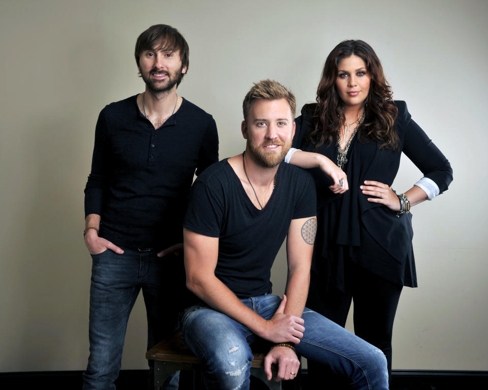 This March 22, 2013 photo shows members of Lady Antebellum, from left, Dave Haywood, Charles Kelley and Hillary Scott in Nashville, Tenn. Even though a cowboy hat sighting on Fifth Avenue is still pretty rare, country music has made an important move into New York City. Country has its own radio station in the nation's largest market for the first time in 17 years. WNSH-FM, which calls itself "NASH 94.7," began broadcasting in January and its operators say it has exceeded expectations for its first few months on the air. For country musicians, the news gets a big yee-haw. "I feel proud for country music," said Dave Haywood of Lady Antebellum. "It shows that you cannot deny where country music is in today's overall music world." (Photo by Donn Jones/Invision/AP)