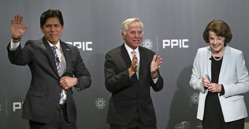 Public Policy Institute of California CEO and debate monitor Mark Baldassare, center, applauds at the end of the debate between California Sen. Kevin de Leon, D-Los Angeles, left, and California Sen. Dianne Feinstein, D-Calif., on Wednesday, Oct. 17, 2018, in San Francisco. Feinstein shared the stage with an opponent for the first time since 2000 when she debated state Sen. Kevin de Leon. The two Democrats are facing off in the Nov. 6 election. (AP Photo/Ben Margot)