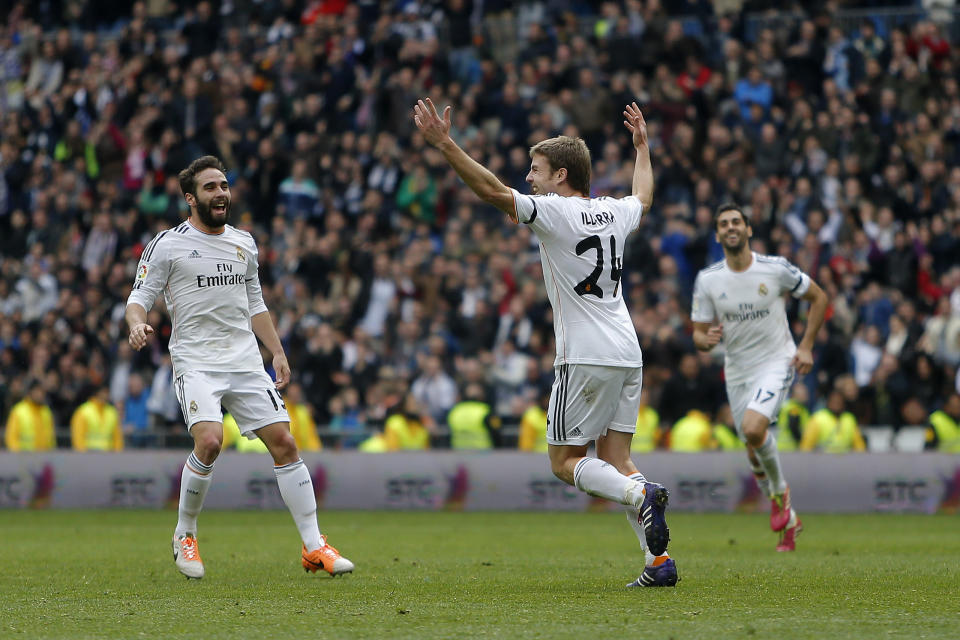 Real Madrid's Asier Illarramendi, centre, celebrates his goal with teammates during a Spanish La Liga soccer match between Real Madrid and Elche at the Santiago Bernabeu stadium in Madrid, Spain, Saturday, Feb. 22, 2014. (AP Photo/Andres Kudacki)