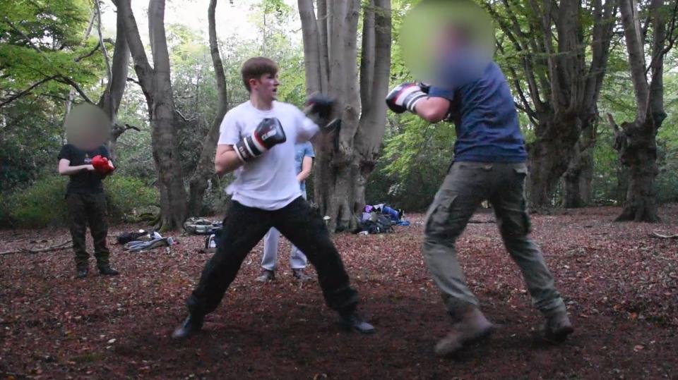 Benjamin Hannam, pictured here boxing outdoors, is the first police officer to be convicted of belonging to a banned neo-Nazi terror groupPA