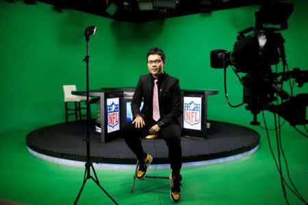 Chinese commentator Wang Zixing poses for a picture after broadcasting a livestream commentary of a NFL American football game in a studio of the media and gaming firm Tencent Holdings in Beijing, China, October 16, 2017. REUTERS/Thomas Peter