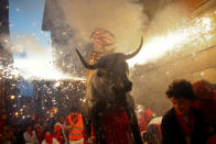 <p>Revelers run from the Fire Bull, a man carrying a bull figure packed with fireworks, at the San Fermin festival in Pamplona, northern Spain, July 13, 2017. (Photo: Susana Vera/Reuters) </p>
