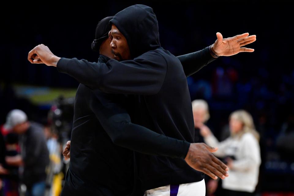 Phoenix Suns forward Kevin Durant (35) greets Los Angeles Lakers forward LeBron James (6) before the game at Crypto.com Arena in Los Angeles on April 7, 2023.