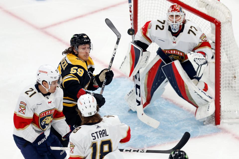 Bruins forward Tyler Bertuzzi battles the Panthers' Nick Cousins (21) and Marc Staal (18) for the puck during the first period of he Bruins' Game 7 loss on Sunday, April 30, 2023, in Boston.