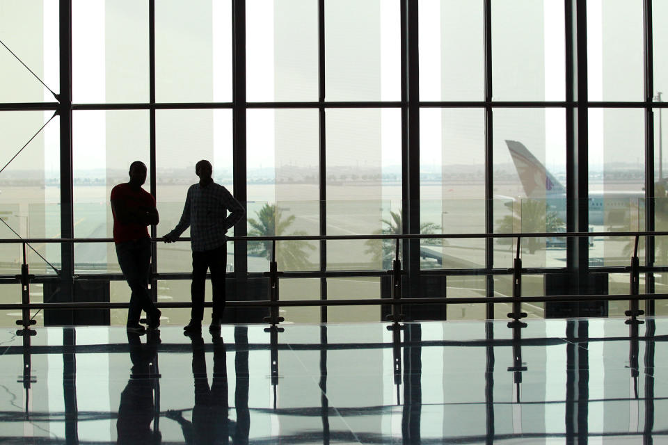 Passengers stand at Hamad International Airport