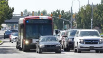 A commuter bus equipped with a radio transmitter passes a connected traffic light on Redwood Road, part of an effort to improve safety and efficiency by allowing cars to communicate with the roadside infrastructure and one another on Friday, Sept. 6, 2024, near Taylorsville, Utah. (AP Photo/Rick Bowmer)