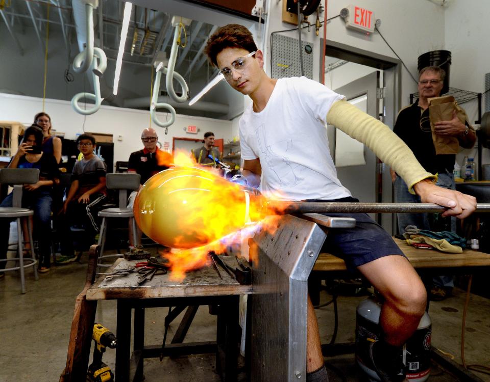 Lead glass blower Mario Clarke of Springfield works on a piece that he said would be a sculpted glass purse when finished during the Edwards Place Fine Arts Fair at the Visual Arts Center in Springfield. The fair returns Sept. 16-17.