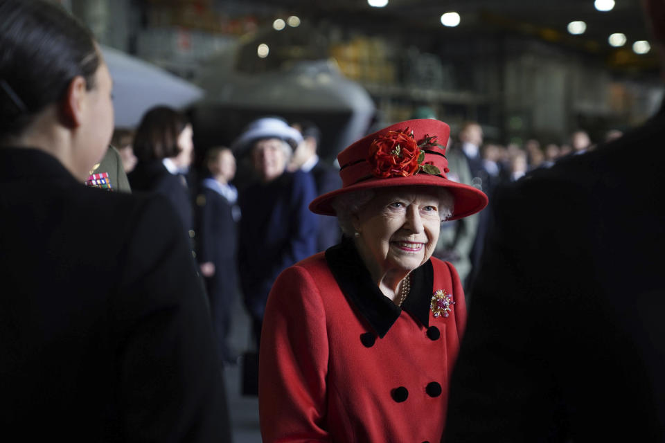 Britain's Queen Elizabeth II smiles during a visit to HMS Queen Elizabeth at HM Naval Base, ahead of the ship's maiden deployment, in Portsmouth, England, Saturday May 22, 2021. HMS Queen Elizabeth will be leading a 28-week deployment to the Far East that Prime Minister Boris Johnson has insisted is not confrontational towards China. (Steve Parsons/Pool Photo via AP)