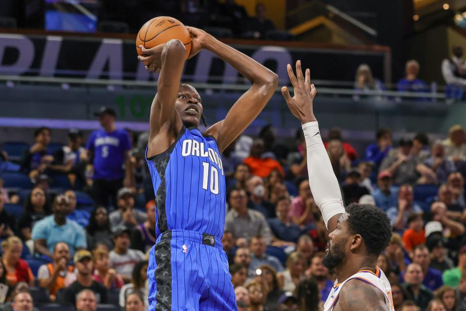 Nov 11, 2022; Orlando, Florida, USA; Orlando Magic center Bol Bol (10) shoots the ball over Phoenix Suns center Deandre Ayton (22) during the second quarter at Amway Center. Mandatory Credit: Mike Watters-USA TODAY Sports